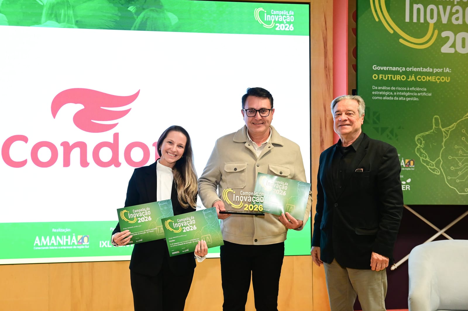 Fernanda Santos, Head de Inovação, e Gilson Gugelmin, Diretor Administrativo, Financeiro e Inovação, da Condor, celebram o 9º lugar conquistado pela empresa no ranking Campeãs da Inovação, do Grupo AMANHÃ.